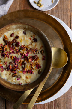Traditional moong dal payasam garnished with nuts, raisins, and rose petals.