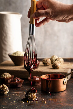 Chocolate drizzled over hemp ball on rustic kitchen surface