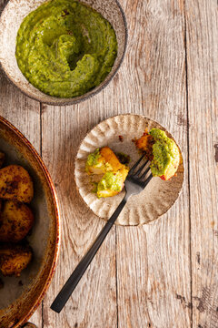Indian-style spiced potatoes served with bright green chutney