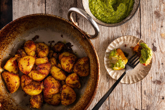 Indian-style spiced potatoes served with bright green chutney