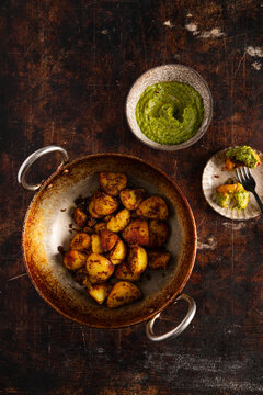 Indian-style spiced potatoes served with bright green chutney