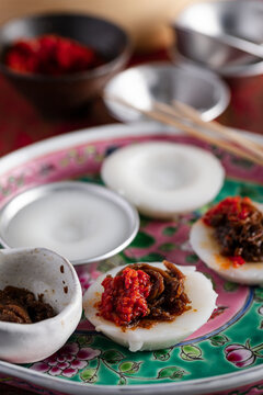 Chwee kueh with pickled radish topping on colorful floral plate