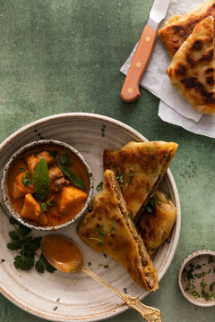 Murtabak with chicken curry on a green table