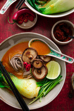 Coconut spice noodle bowl with mushrooms, bok choy, lime and chilies