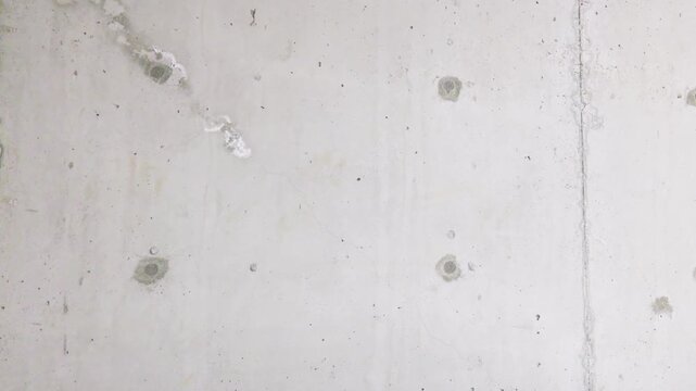 Bare architectural concrete wall background texture with tie rod holes, copy space for text and graphics
