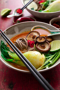Coconut spice noodle bowl with mushrooms, bok choy, lime and chilies