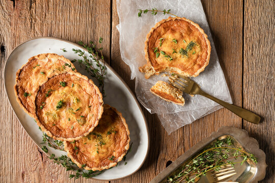 Mini quiches with a piece broken off with a fork