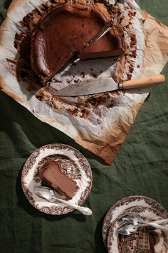 Rich malted chocolate Basque cheesecake with biscuit base and rustic styling.