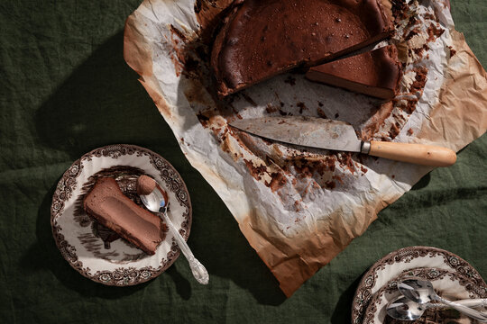Rich malted chocolate Basque cheesecake with biscuit base and rustic styling.