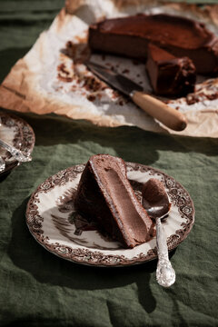 Rich malted chocolate Basque cheesecake with biscuit base and rustic styling.