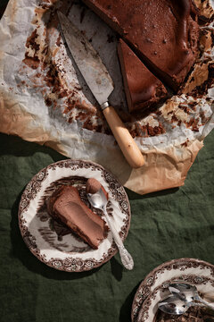 Rich malted chocolate Basque cheesecake with biscuit base and rustic styling.