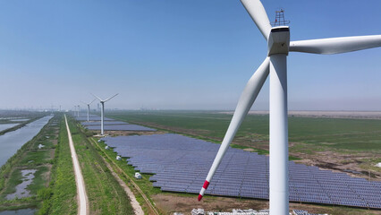 Wind turbines and solar panels for renewable energy generation in a green field © zhu difeng