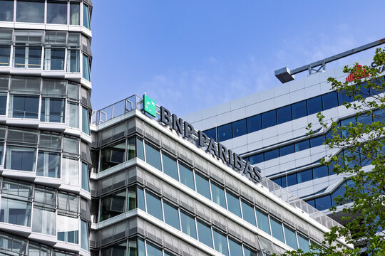 Amsterdam, Netherlands - May 23, 2026: The BNP Paribas logo mounted on the top of a modern, multi-story glass office building in the Amsterdam Zuidas financial and business district.