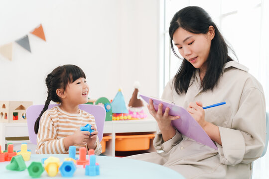 Teacher child girl learning classroom play education happy notebook pen