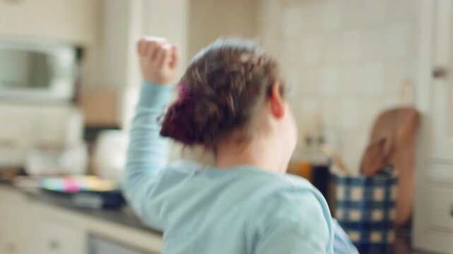 Dancing, child and happy with spin in kitchen for childhood freedom, fun movement and development. Growth, kid and energy with rhythm in house for self expression, weekend entertainment and wellness