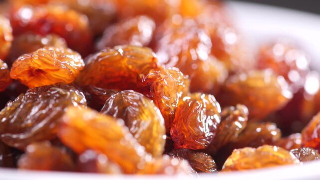 Rotating 4K shot of sun-dried South African raisins, grown in the Northern Cape Orange River area renowned for some of the longest daylight hours in the world. Camera movement: slight pan to right.