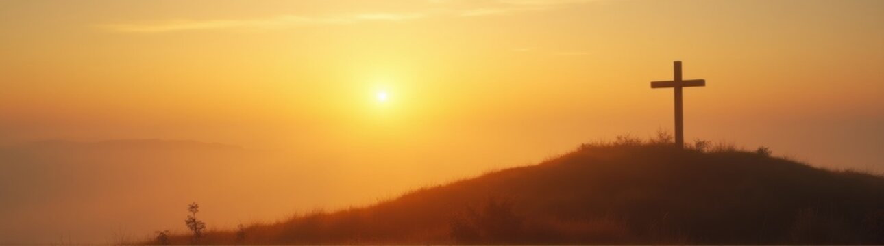 Cross on a hill with a sunset in the background