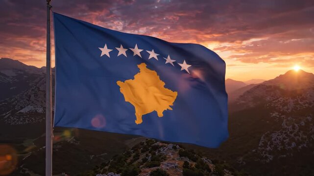 Flag on mountain peak at sunset
