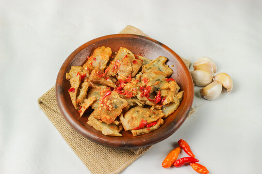 Tahu kocek, or geprek aci tofu, is a popular snack originating from Jember, East Java, Indonesia. It's made from fried tofu pieces filled with tapioca flour batter and served with onion chili sauce.