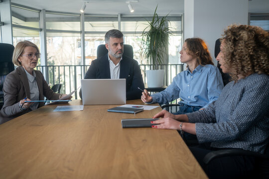 Workplace disagreement between different generations during office discussion