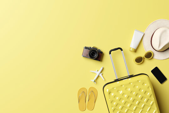 Summer travel accessories flat lay on yellow background