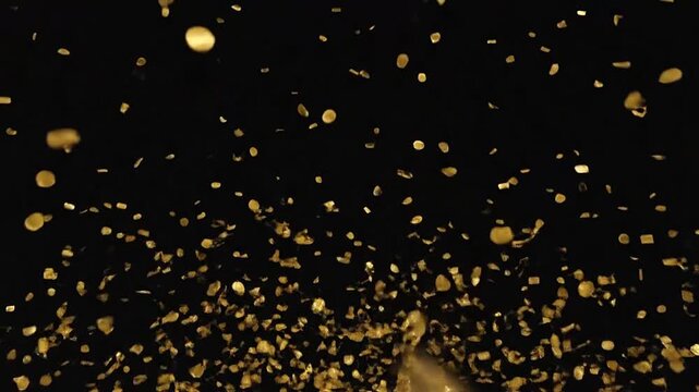 A multitude of golden particles float against a deep black background