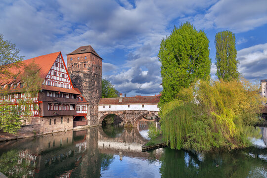 Historic Weinstadel wine depot with wooden bridge and tower on Pegnitz river in Nuremberg, Germany. Medieval heritage, daylight