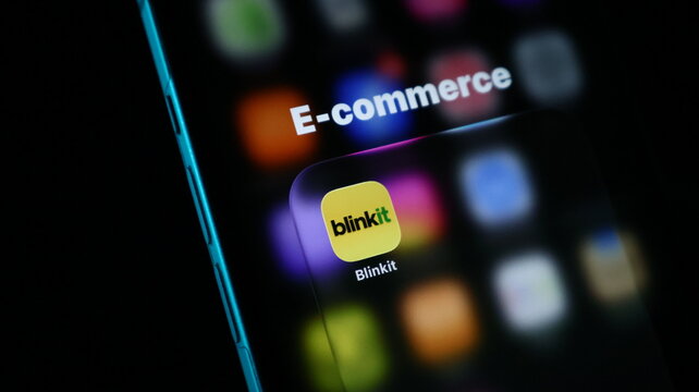 Closeup of a smartphone screen displaying the blinkit app icon inside an ecommerce folder, highlighting modern digital shopping convenience