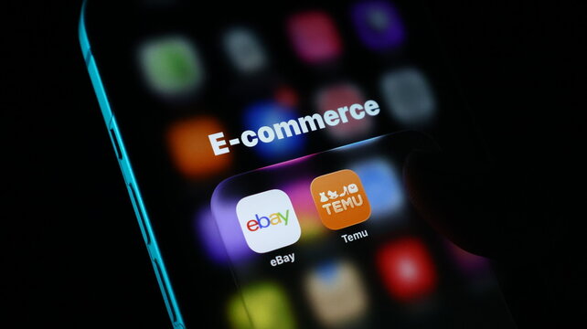Closeup of a smartphone screen showing an ecommerce folder containing ebay and temu mobile applications