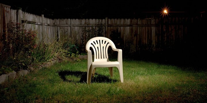 White Plastic Chair in Garden at Night, Illuminated by Moonlight