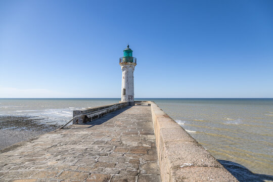 Historic White and Green Lighthouse on a Stone Pier