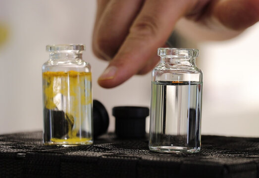 Small glass vials containing liquid solutions, used for bioavailability testing, cosmetic formulation, or chemical analysis. An ideal image for scientific articles, laboratories, research, supplements