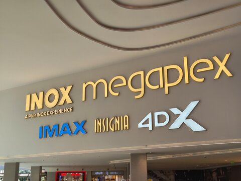 INOX Megaplex cinema branding inside a luxury mall reflects PVR INOX merger, OTT competition, profit, loss and quarterly results shaping India's evolving entertainment business and retail growth boom.