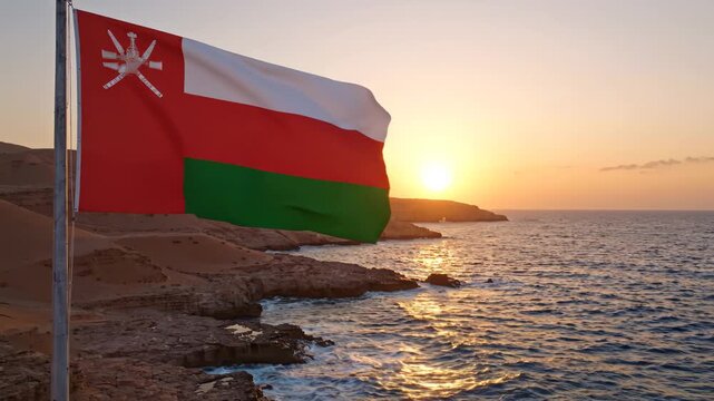 Oman flag at sunset by sea