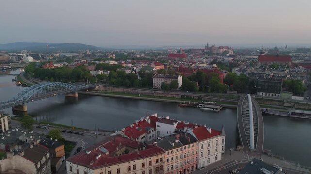 Aerial flyover of Krakow's Old Town and the Vistula River at dawn in spring