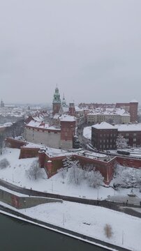 Aerial flyover of Wawel Castle in Krakow during the day in winter