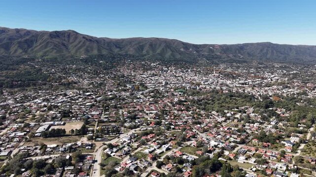 Aerial drone shot of La Falda city in the scenic Punilla Valley, Cordoba, Argentina.