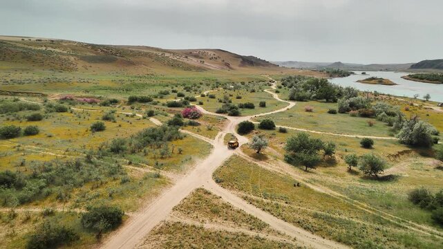 Aerial View offroad vehicle near river in South Kazakhstan
