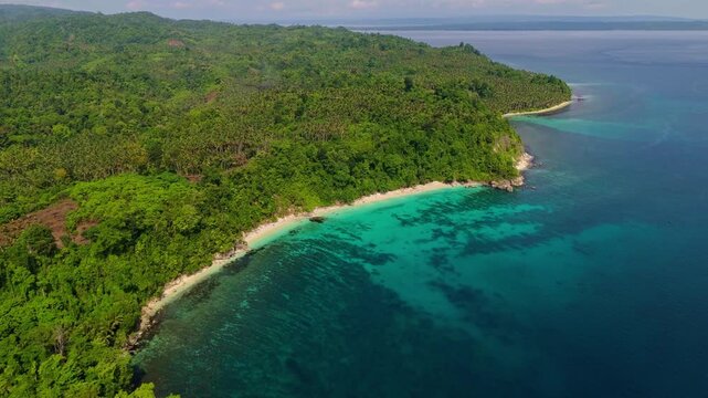 Cinematic aerial view of Mandel Beach on Banggai Island &ndash; Breathtaking drone shot of white sandbar and vibrant coral reef in crystal clear turquoise ocean, Central Sulawesi Indonesia paradise 4k