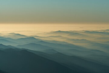 Obraz premium Low angle view of dawn contours revealing fog banks over rolling hills in pale light