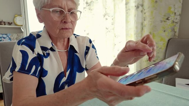 Senior Woman Using Smartphone at Home
