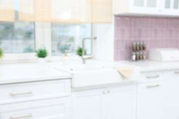 Fototapeta premium Blurred view of stylish kitchen interior with sink near window