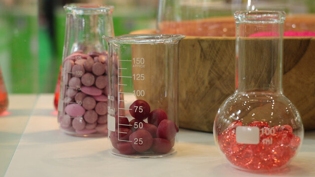 Glass laboratory jar filled with nutraceutical gummies used for supplements, wellness products or formulation testing. Ideal for content related to health, nutrition, supplements, laboratory research 