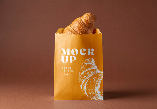 Brown kraft paper bakery bag mockup with fresh croissant inside isolated on a brown studio background