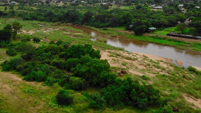 Scenic Aerial Shot Showing River Winding Through Lush Green Wetlands And Riparian Woodlands . Media