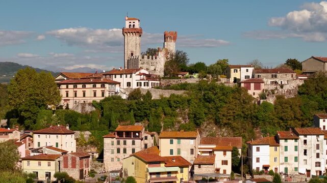 Heron on tree branch close up. Nozzano Castle Lucca Tuscany Aerial 4K. Drone cinematic 70m reveal flyout from wild bird to medieval village panorama. Tuscan countryside rolling hills hidden gems