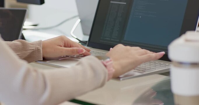 Seeing code editor, female coder typing, tapping touchpad at desk, pointing at laptop, editing code