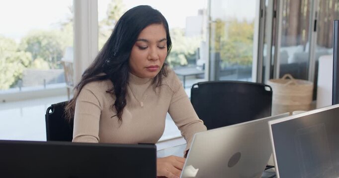 Diverse female coworkers talking at desk while colleague rubbing head after screen bug, fixing PC
