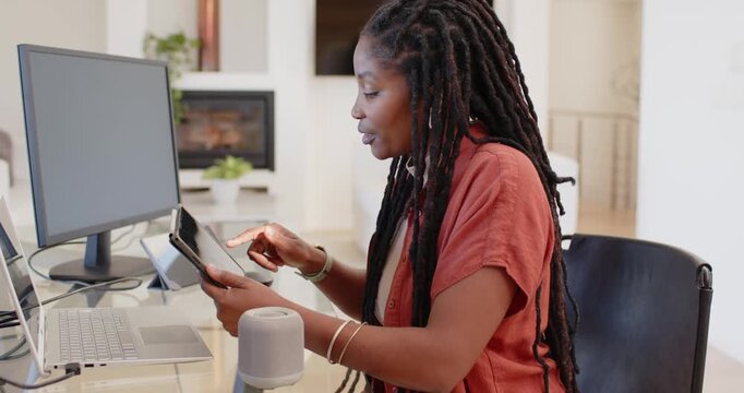 Ping showing African woman rotating phone to angled stand, tapping, checking screen at home office