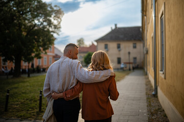 Loving couple embracing walking city street at sunset © Zoran Jesic